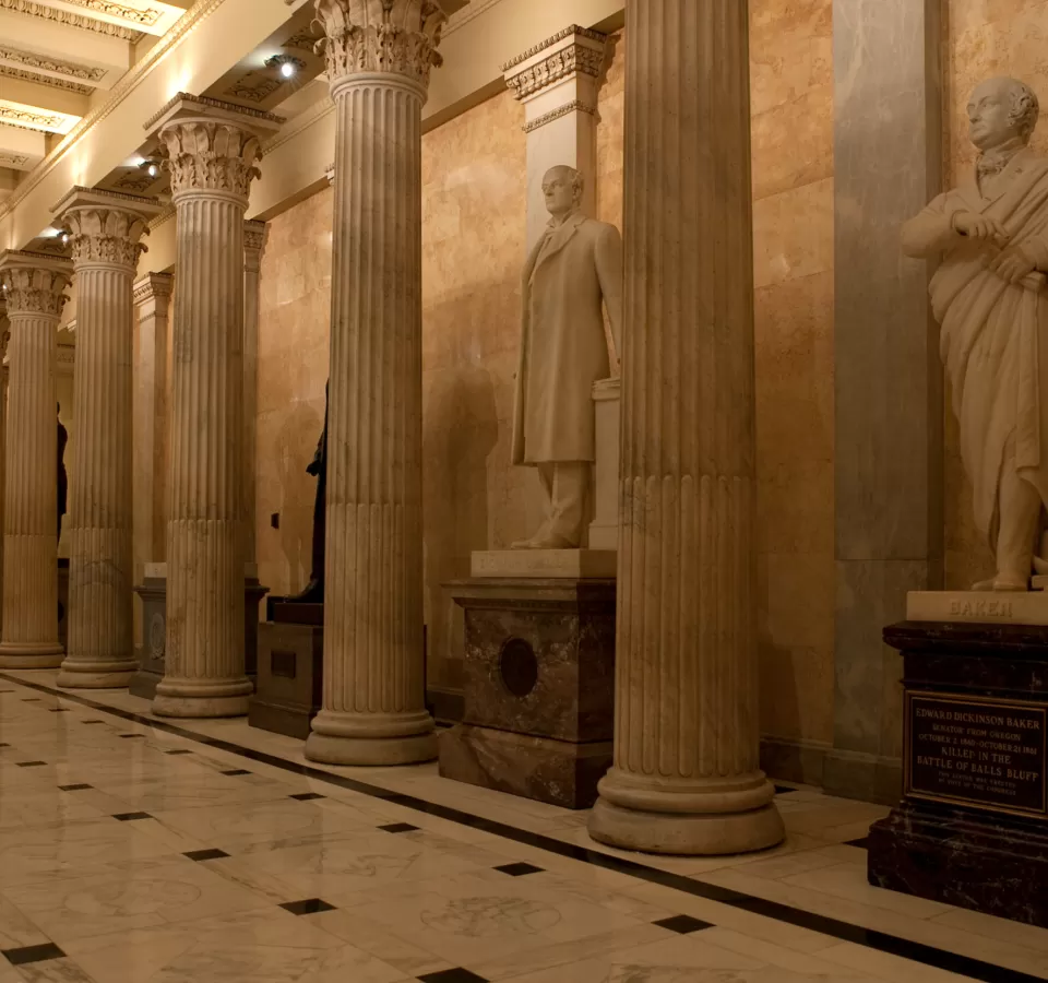 Columns in a room with statues.